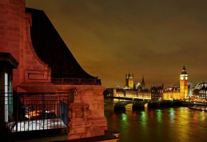 London Marriott Hotel County Hall view. Gay-friendly hotel room's balcony overlooking the Thames, Houses of Parliament, and Big Ben at night.