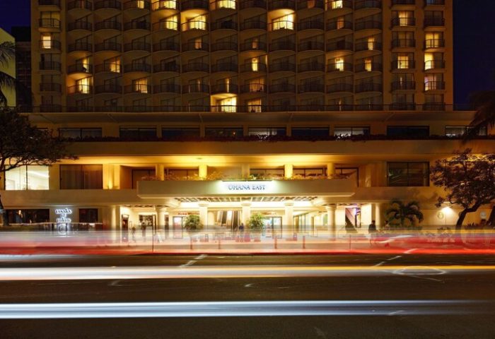 OHANA Waikiki East by OUTRIGGER at night. Gay-friendly hotel in Waikiki, Hawaii. Car light trails in front of the hotel entrance.