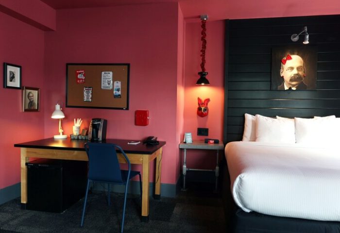 Hotel Gaythering, a gay-friendly hotel. All adults welcome. Room interior with bed, desk, and quirky decor. Gay men's travel advice.