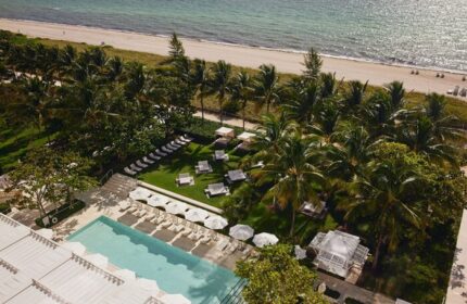 Four Seasons Hotel at The Surf Club aerial view. Gay-friendly hotel with pool, beach, palm trees, and cabanas. Luxury travel for gay men.