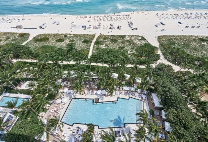 Aerial view of W South Beach, a gay-friendly hotel. Pool, palm trees, beach, and ocean. Ideal for gay travel and vacation.