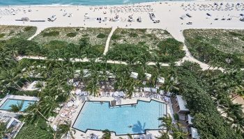 Aerial view of W South Beach, a gay-friendly hotel. Pool, palm trees, beach, and ocean. Ideal for gay travel and vacation.