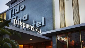 The Standard Miami, a gay-friendly hotel. Facade with Lido Spa and The Standard signage. A great choice for gay men's travel in Miami.