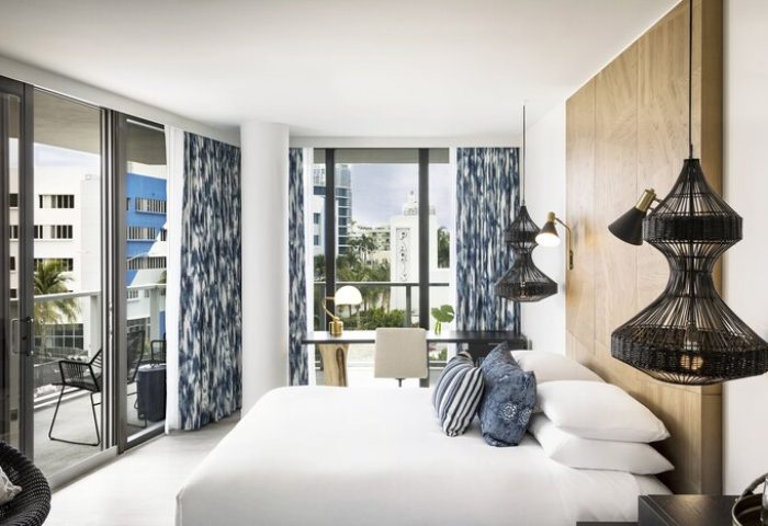 Kimpton Angler's Hotel room. Modern design, white linens, blue accents, balcony. Gay-friendly hotel for travel. Miami Beach hotel interior.