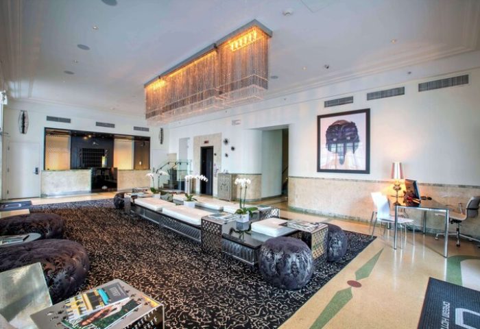 Dream South Beach, Hyatt hotel lobby. Gay-friendly hotel with modern design, seating area, and chandelier. Ideal for gay travel in Miami.