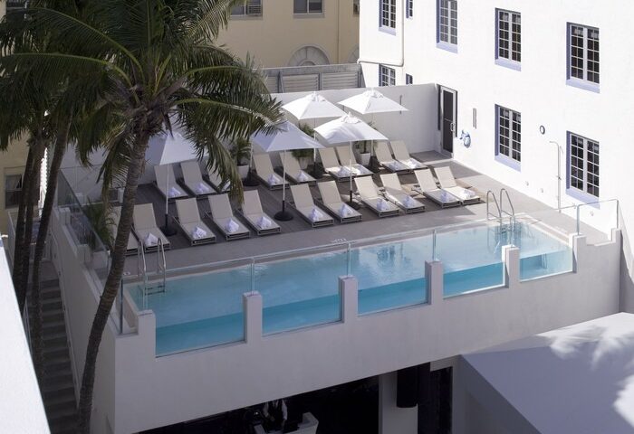 Rooftop pool at the gay-friendly Hotel Breakwater South Beach. Lounge chairs and umbrellas offer relaxation in this Miami Beach hotel.