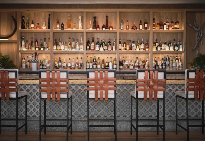 Bar at 1 Hotel San Francisco. Gay-friendly hotel bar with leather woven barstools and a fully stocked liquor shelf. Enjoy drinks at this hotel.