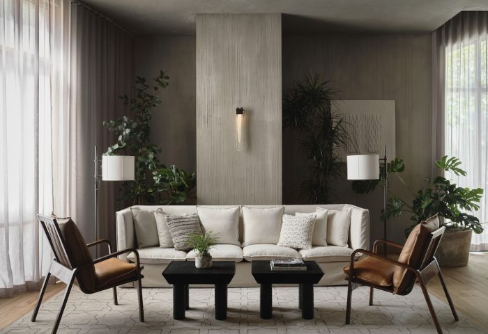 1 Hotel San Francisco: Chic, gay-friendly hotel lounge area with sofa, chairs, plants, and modern decor. A stylish space for gay travelers.