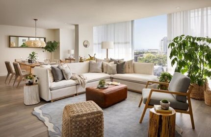 1 Hotel Toronto living room. Gay-friendly hotel with stylish decor, a large sectional sofa, and city views. Perfect for gay travelers.