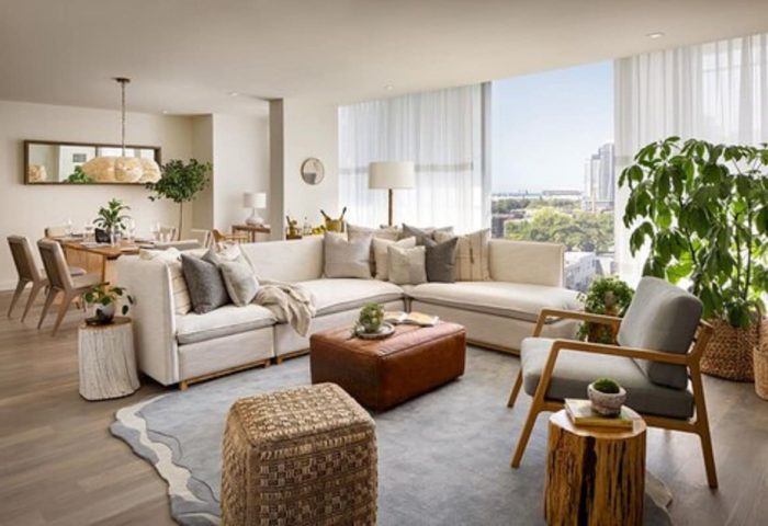 1 Hotel Toronto living room. Gay-friendly hotel with stylish decor, a large sectional sofa, and city views. Perfect for gay travelers.