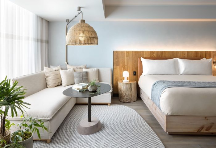1 Hotel Toronto: Gay-friendly hotel room with a bed, couch, and unique lighting. A stylish, welcoming space for gay travelers. #TorontoHotel