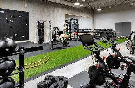 1 Hotel Toronto gym. Gay-friendly hotel fitness center with Peloton bikes, weights, climbing wall, and modern equipment for a complete workout.