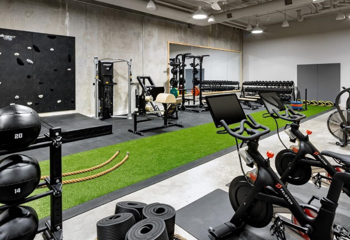1 Hotel Toronto gym. Gay-friendly hotel fitness center with Peloton bikes, weights, climbing wall, and modern equipment for a complete workout.