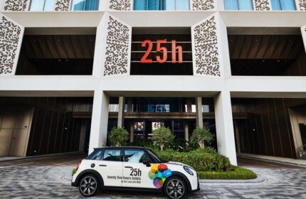 25hours Hotel One Central facade with a branded Mini Cooper. A gay-friendly hotel, offering unique experiences for gay travelers.