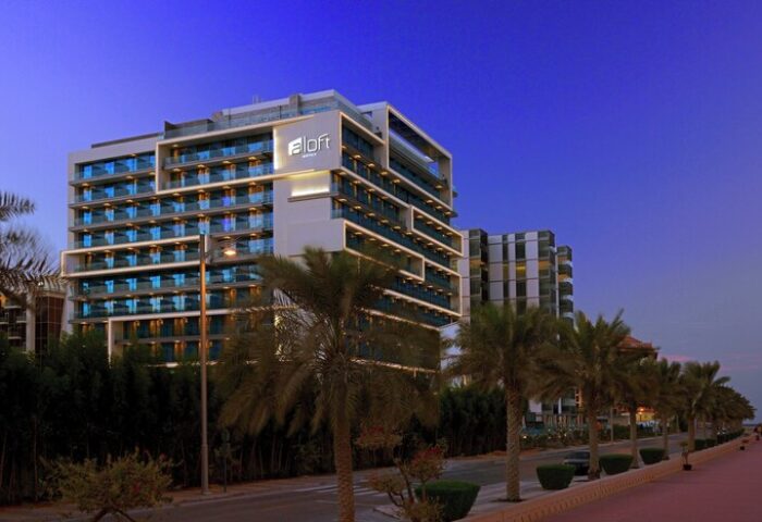 Aloft Palm Jumeirah, a gay-friendly hotel. Modern architecture, palm trees. A great choice for gay men's travel, offering a welcoming stay.