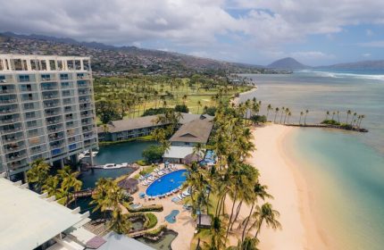 Aerial view of The Kahala Hotel and Resort, a gay-friendly hotel. Beachfront property with pool, palm trees, and ocean views. Perfect for gay travel.