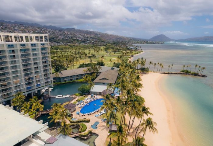 Aerial view of The Kahala Hotel and Resort, a gay-friendly hotel. Beachfront property with pool, palm trees, and ocean views. Perfect for gay travel.
