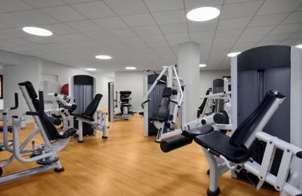 Sheraton Waikiki Beach Resort's gym. A gay-friendly hotel with modern exercise machines on a wood floor. Fitness center for gay men's travel.