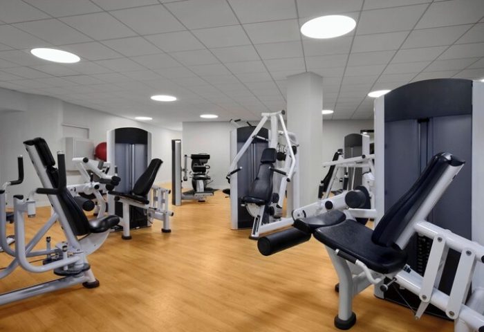 Sheraton Waikiki Beach Resort's gym. A gay-friendly hotel with modern exercise machines on a wood floor. Fitness center for gay men's travel.