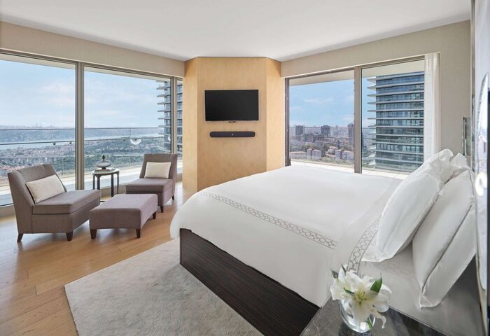 Raffles Istanbul Hotel gay-friendly room. Modern bedroom interior with city view. Luxury hotel for gay travel in Istanbul. Gay hotel.