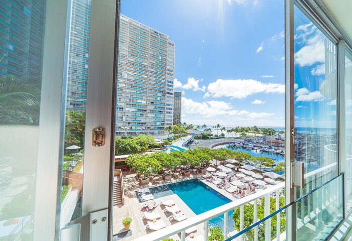 View from The Modern Honolulu, a gay-friendly hotel. See the pool, marina, and ocean. A perfect vacation club for gay men's travel.