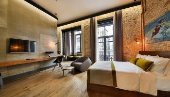 Hotel The Public Special Category room. Gay-friendly hotel. Modern design with exposed brick, wood floors, and city view. Comfortable and stylish.
