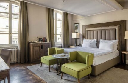 The Bank Hotel Istanbul room. Gay-friendly hotel with bed, chairs, and windows. Design Hotels™ member, inviting for gay travelers.