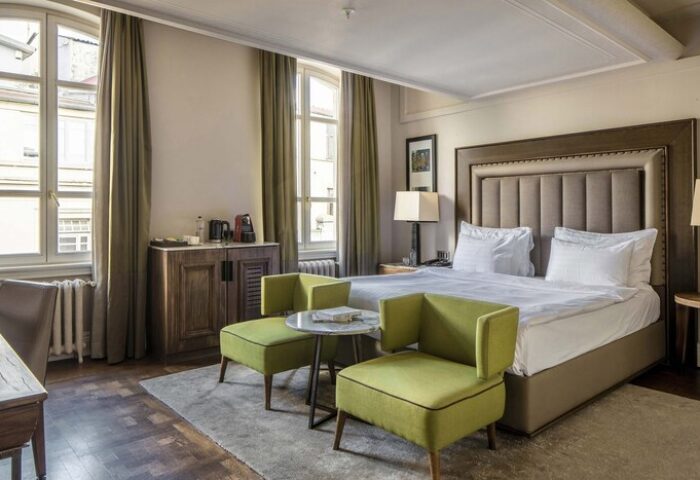 The Bank Hotel Istanbul room. Gay-friendly hotel with bed, chairs, and windows. Design Hotels™ member, inviting for gay travelers.