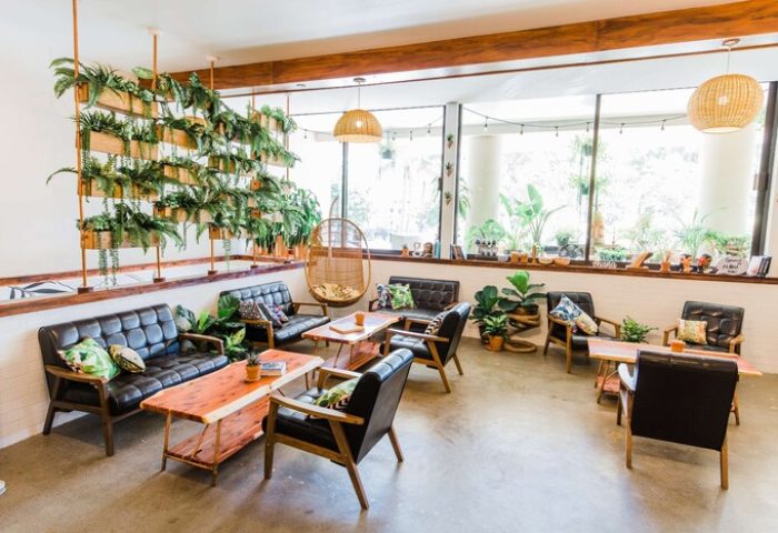 OHANA Waikiki East by OUTRIGGER's stylish lounge. This gay-friendly hotel features modern seating, plants, and a relaxed vibe.