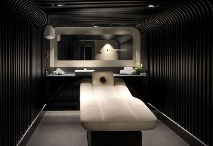 NYX Hotel London Holborn spa room. Massage table, sink, and mirror. Gay-friendly hotel with wellness amenities for gay men travelers.