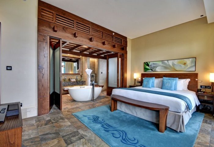 Sofitel Dubai The Palm Resort And Spa gay-friendly hotel room. Luxurious bedroom and bathroom with tub. Perfect for LGBT travel.
