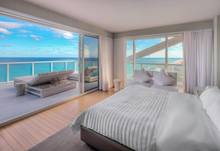 W Fort Lauderdale gay-friendly hotel room with ocean view. Balcony with lounge chairs. Luxury travel for gay men.