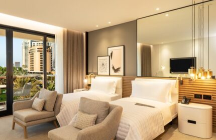 Le Royal Méridien Beach Resort gay-friendly hotel room. Two beds, balcony view. A great choice for gay men's travel.