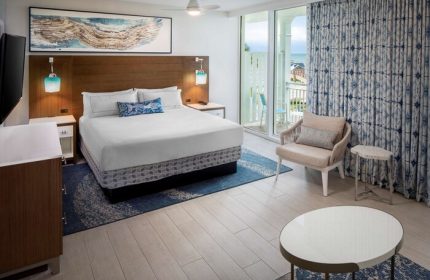 The Reach Key West, Curio Collection by Hilton hotel room. Gay-friendly hotel with a bed, balcony, and ocean view.