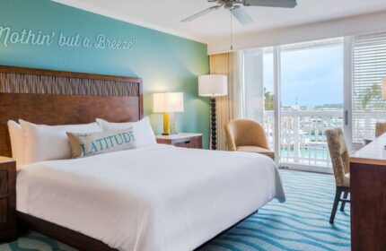Opal Key Resort and Marina room. Gay-friendly hotel with marina view. Nothin' but a Breeze wall art above the bed. Balcony overlooking the water.