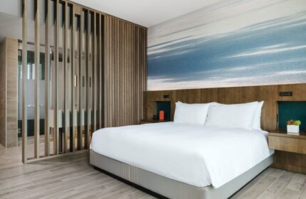 EAST Miami gay-friendly hotel room. Modern design with a king-size bed, wood accents, and a stylish bathroom. Perfect for gay travel.