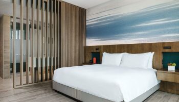 EAST Miami gay-friendly hotel room. Modern design with a king-size bed, wood accents, and a stylish bathroom. Perfect for gay travel.