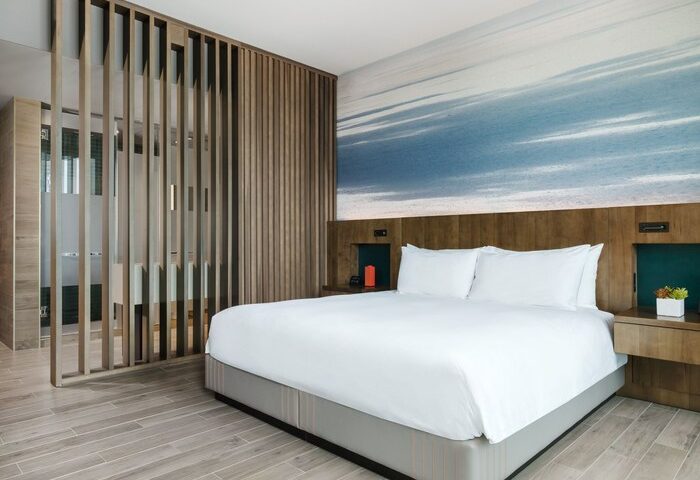 EAST Miami gay-friendly hotel room. Modern design with a king-size bed, wood accents, and a stylish bathroom. Perfect for gay travel.
