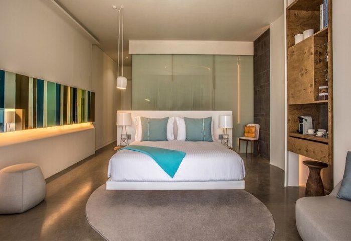 Nikki Beach Resort & Spa Dubai gay-friendly hotel room. Modern design with bed, lamps, and decor. Ideal for gay men's travel and relaxation.