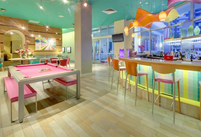 Hampton Inn & Suites Miami/Brickell-Downtown gay-friendly hotel bar and lounge area. Pink pool table and colorful decor. Gay travel advice.