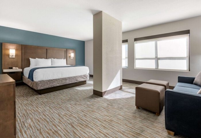Comfort Inn & Suites Downtown Brickell-Port of Miami gay-friendly hotel room. King bed, sofa, & modern decor. Perfect for gay travel.