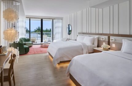 W South Beach gay-friendly hotel room with two beds, balcony, ocean view, and modern decor. Luxury gay travel in Miami.