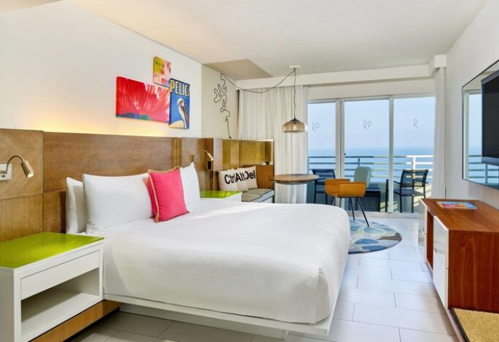 Royal Palm South Beach Miami gay-friendly hotel room. Tribute Portfolio Resort suite with ocean view balcony, bed, and modern decor.