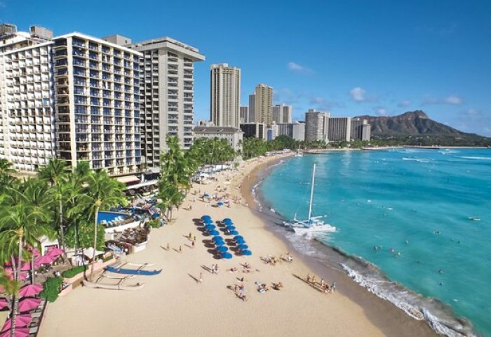 Waikiki Beach Resort view. Outrigger Hotel on the beach, Diamond Head in the distance. Gay-friendly hotel for gay men's travel advice.