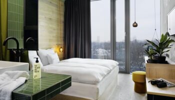 25Hours Bikini Berlin gay-friendly hotel room. Modern design, large window, bed, and bathroom. Great for gay travel in Berlin.