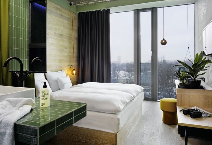 25Hours Bikini Berlin gay-friendly hotel room. Modern design, large window, bed, and bathroom. Great for gay travel in Berlin.