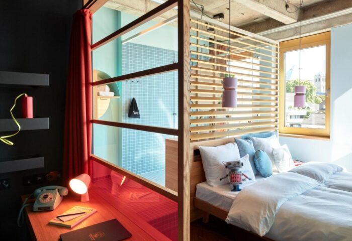 25hours Hotel The Circle room. Gay-friendly hotel design with a shower, desk, and bed. Modern, stylish interior. Great for gay travel.