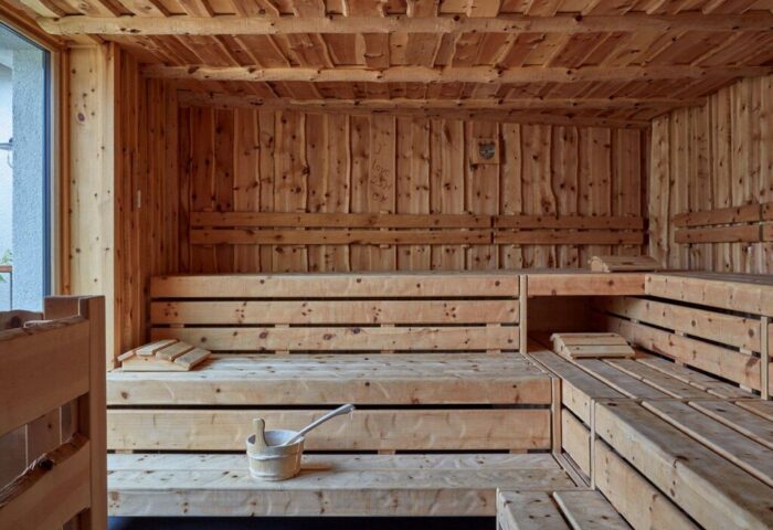 Sauna at 25hours Hotel The Royal Bavarian, a gay-friendly hotel. Wooden benches, walls, ceiling, and bucket. Relaxing spa for gay travelers.