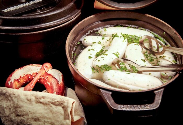 25hours Hotel The Royal Bavarian: Traditional Bavarian Weißwurst in a pot with pretzel. Gay-friendly hotel food experience.