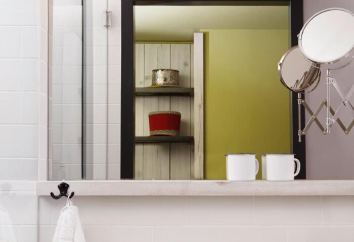 Bathroom at 25hours Hotel beim MuseumsQuartier, a gay-friendly hotel. Features sink, mirror, mugs, & toiletries. Vienna travel.